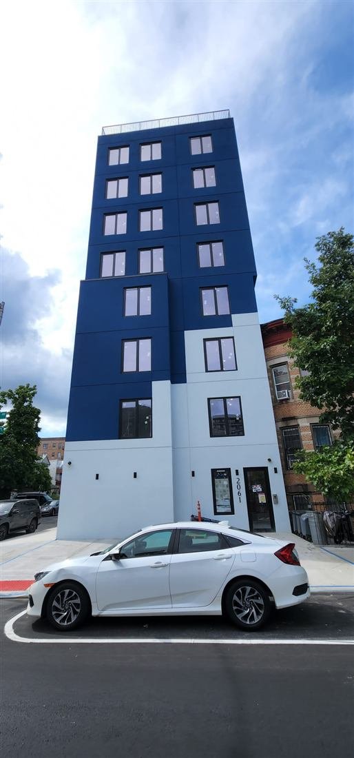 Tekno Construction exterior facade restoration in progress in New York — repointing, stone repair and parapet work of the kind churches need