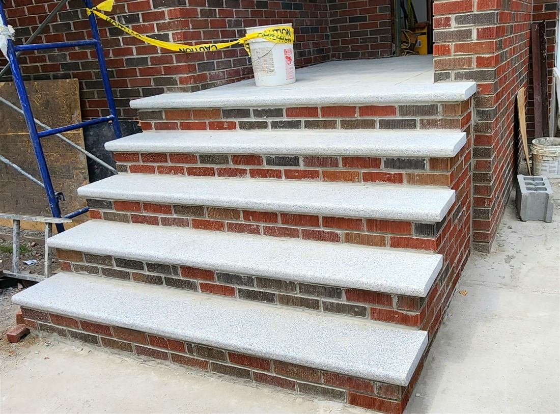 Stone and brick retaining wall repair by Tekno Construction masons in NYC