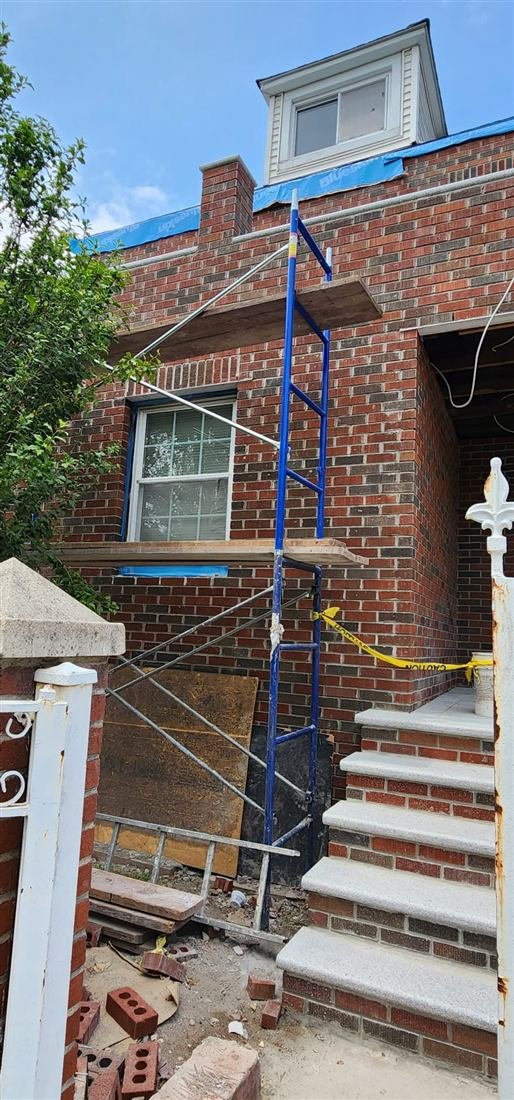 Tekno Construction masons restoring brick and stone masonry in NYC — the same repointing and rebuilding craft our church restoration work is built on