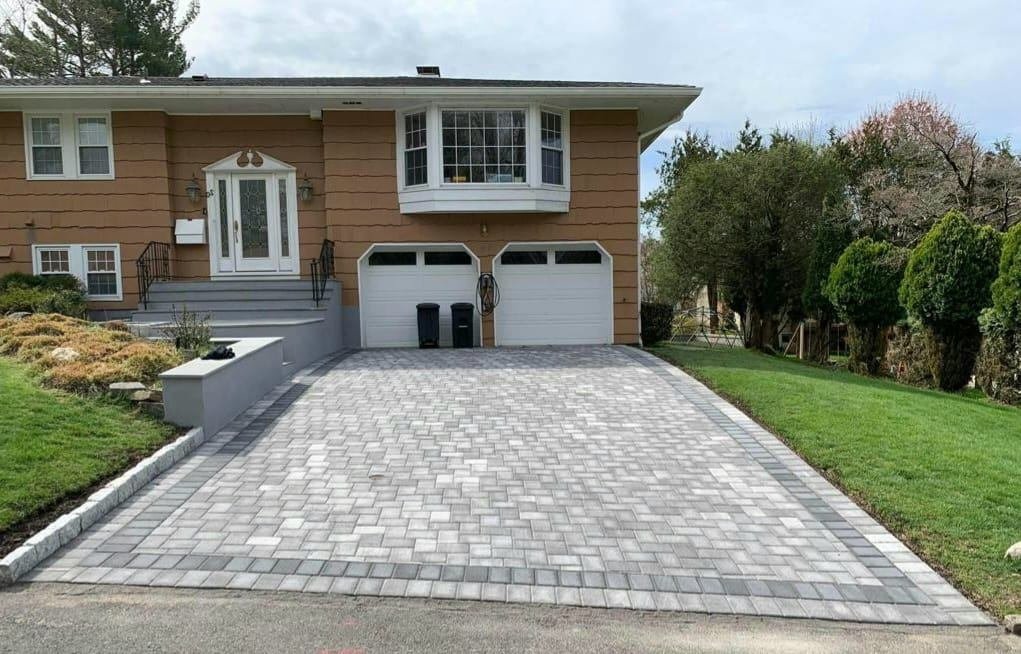 Interlocking paver driveway with charcoal border installed by Tekno Construction
