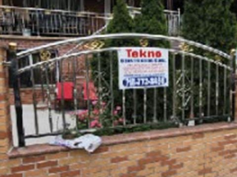 Brick facade with iron fence completed by Tekno Construction