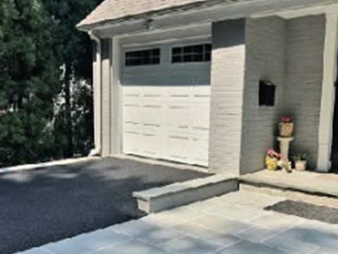 New asphalt driveway with paver border and garage by Tekno Construction