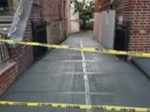 Freshly poured concrete sidewalk with DOT caution tape — violation removal by Tekno Construction